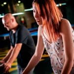 Young woman playing pinball in game room