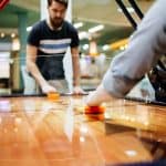 Employees playing air hockey