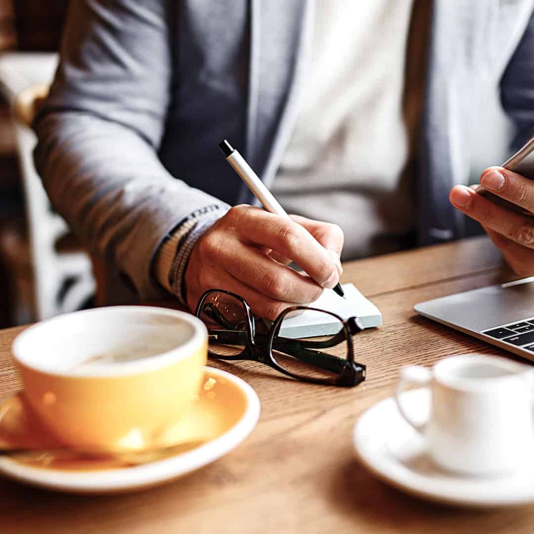 Old mocha coffee machine with businessman hands checking the time