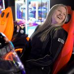 Girl smiling at arcade game